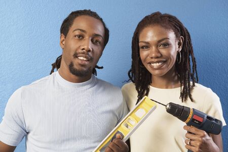 African couple with level and power drill の写真素材
