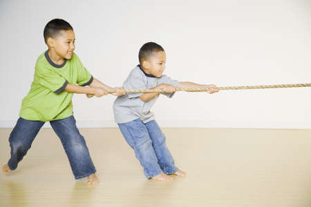 African brothers playing tug of warの写真素材