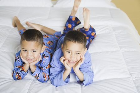 Portrait of African brothers on bedの写真素材