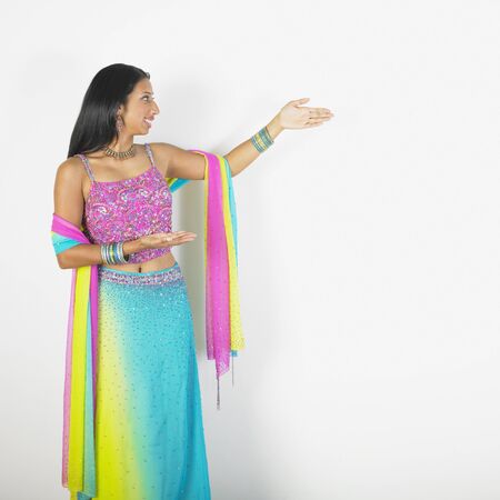 Indian woman making welcoming gestureの写真素材