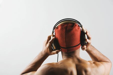 Asian man listening to headphonesの写真素材