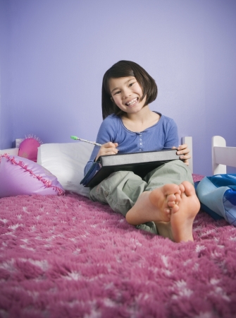 Asian girl doing homeworkの写真素材