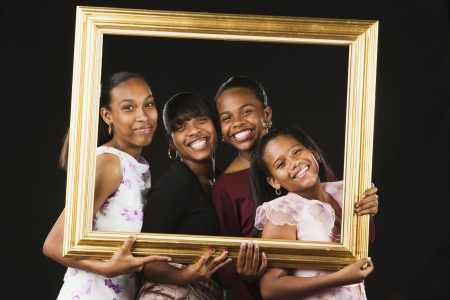 African sisters posing in picture frameの写真素材