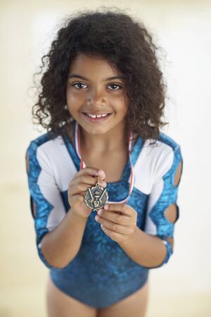 Young female gymnast wearing medalの写真素材