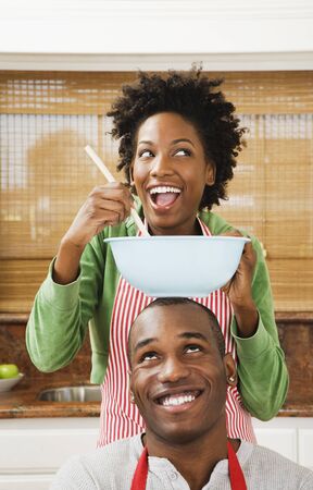 African American couple baking in kitchenの写真素材