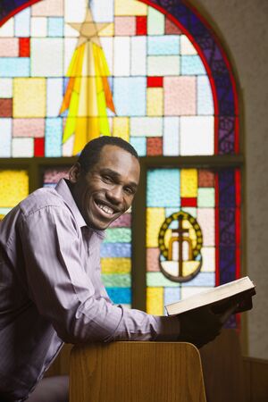African American man with Bible in churchの写真素材
