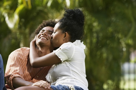 South American couple kissing in parkの写真素材