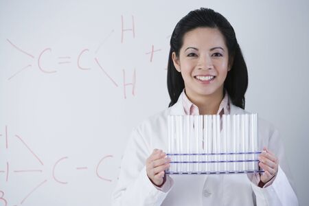 Asian female scientist holding rack of vialsの写真素材