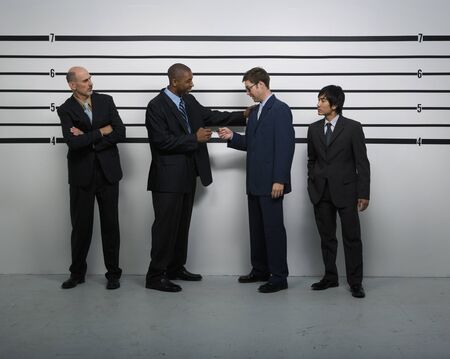 Multi-ethnic businessmen in police line upの写真素材