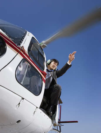 Asian businessman in helicopterの写真素材