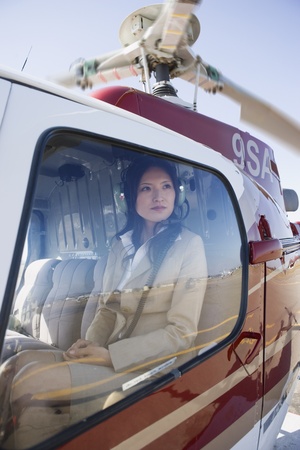 Asian businesswoman in helicopterの写真素材