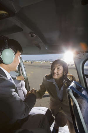 Asian businesswoman getting into helicopterの写真素材