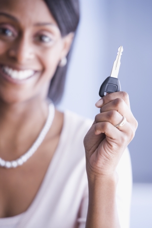 African American woman holding car keyの写真素材