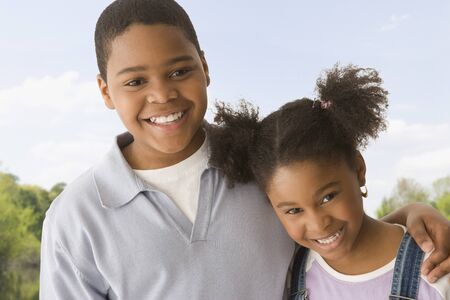 African American brother and sister huggingの写真素材