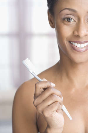 African American woman holding toothbrushの写真素材