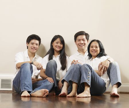 Portrait of Asian family on floorの写真素材