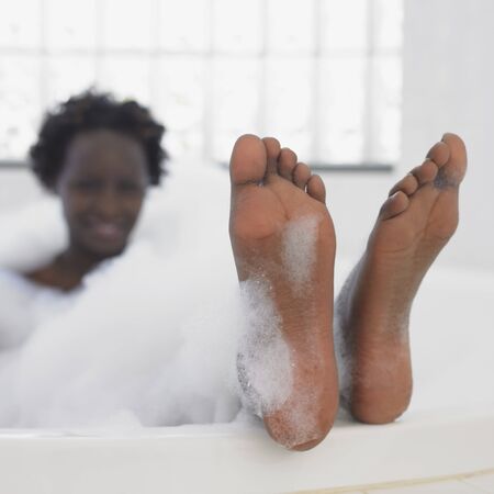 African woman in bubble bathの写真素材