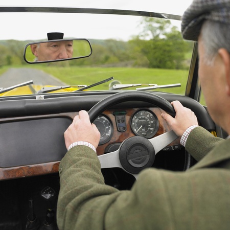 Senior Asian man driving old fashioned carの写真素材