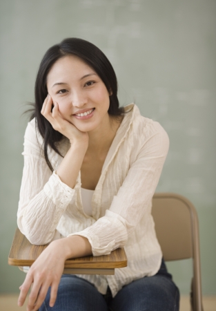 Asian woman sitting at school deskの写真素材