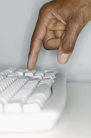 Human hand operating a computer keyboard,の写真素材