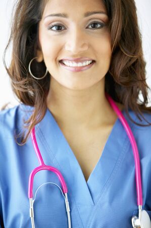 Portrait of a female doctor standing with a stethoscope around her neckの写真素材