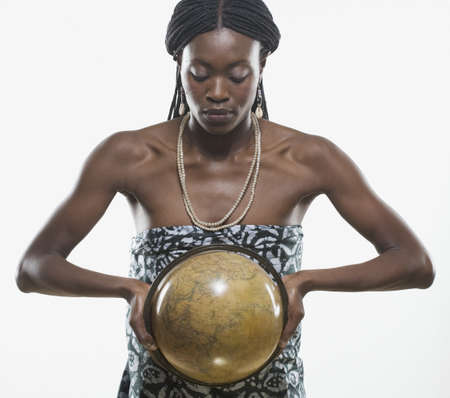 Close-up of a mid adult woman holding a globeの写真素材