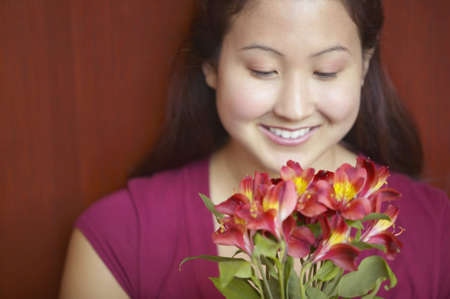 Young woman holding flowersの写真素材
