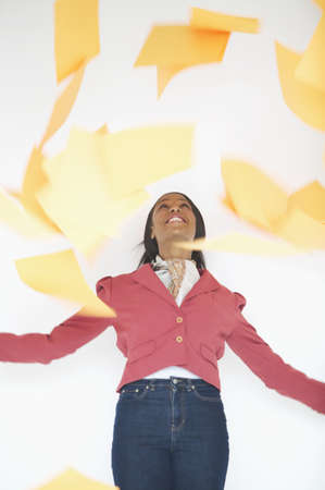 Woman throwing papers into air