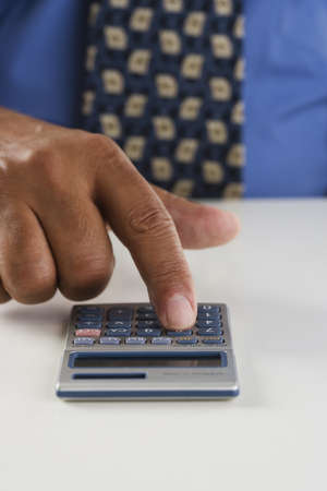 Close up of businessmanÃƒÂ­s hand using calculator