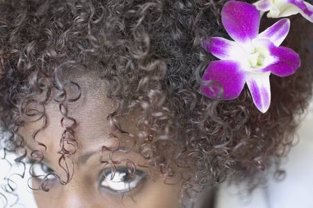 Close up of woman with flower in hairの写真素材