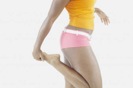 Mid section of woman stretching
