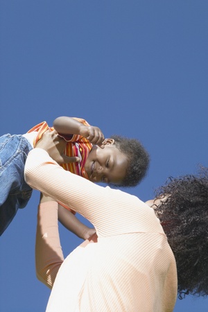 Mother holding son in airの写真素材