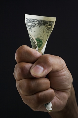 Close up of hand holding dollar bill