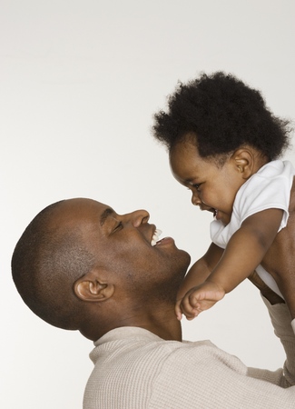 Father playing with his baby daughterの写真素材