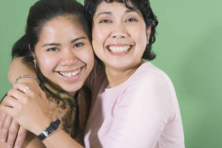 Mother and daughter smiling for the cameraの写真素材
