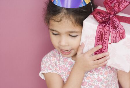 Girl with birthday gift and hatの写真素材