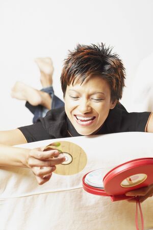 Young woman picking out a CDの写真素材