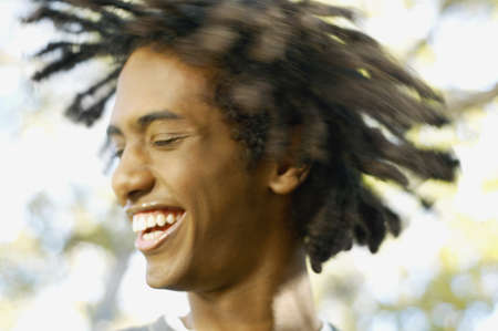 Teenage boy tossing his dreadlocksの写真素材