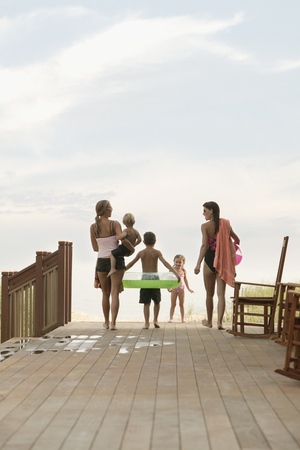 Family walking towards the beachの写真素材