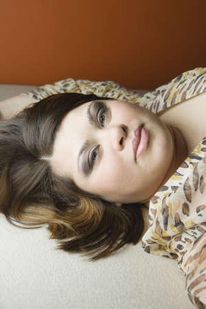 Close up of young woman lying on the floorの写真素材