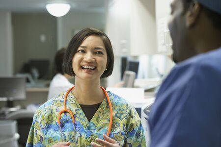 Female nurse talking to co-worker, Bethesda, Maryland, United Statesの写真素材
