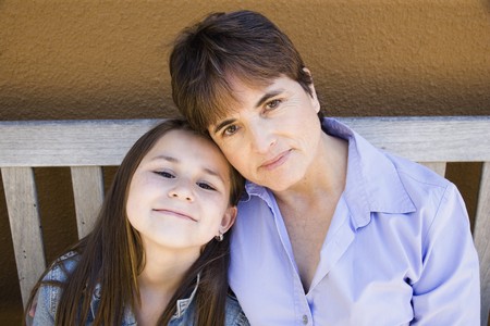 Hispanic mother and daughter hugging