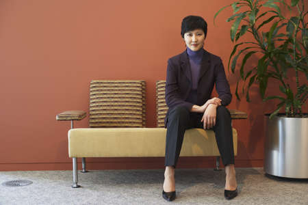 Asian businesswoman in waiting areaの写真素材
