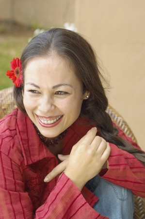 Woman smiling with flower in her hairの写真素材