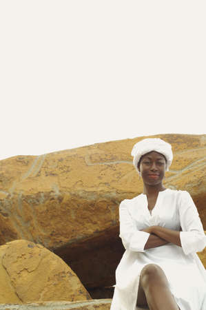 African American woman sitting on rocksの写真素材
