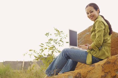 Woman with laptop outdoorsの写真素材