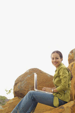 Woman with laptop outdoorsの写真素材