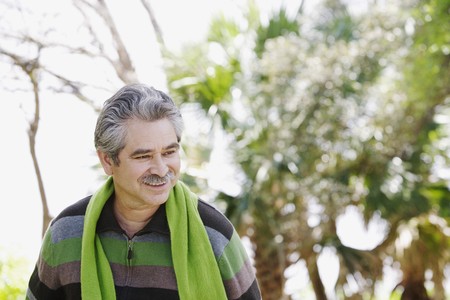 Middle-aged man walking outdoorsの写真素材