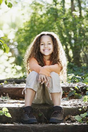 Young African girl smiling in woodsの写真素材