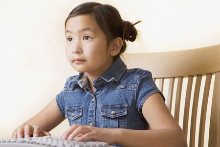 Young Asian girl using computerの写真素材